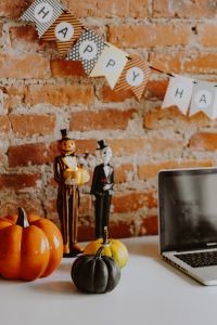 Kaboompics - Halloween Laptop Workspace With Pumpkins and Garland