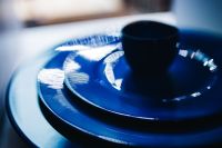 Kaboompics - Blue Ceramic Dinnerware with Dark Cup and Reflections