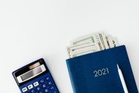 Kaboompics - Money Management Flat Lay with a 2021 Planner and Calculator