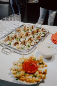 Kaboompics - Overhead Buffet Platter of Savory Canapes with Dip and Rows of Glasses