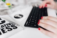 Kaboompics - Female hands typing on the remote wireless computer keyboard