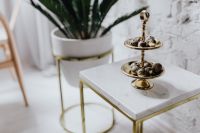 Kaboompics - Gold Tiered Server of Quail Eggs on a Marble Side Table