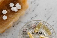 Kaboompics - White Tablets and Golden Capsules in a Crystal Bowl