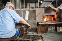 Kaboompics - Seated Glassworker Shaping Molten Glass at the Murano Furnace