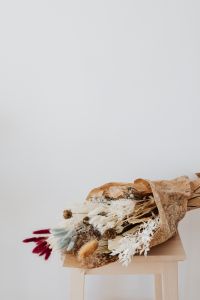 Kaboompics - Vertical Dried Flower Arrangement with Burgundy Stems and Open Neutral Copy Space