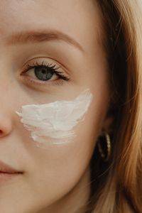 Kaboompics - Woman Applying a Thick Layer of Face Cream to Her Cheek