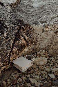 Kaboompics - Cropped White Handbag and Pebbles at the Shoreline