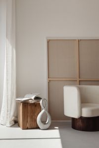 Kaboompics - Minimalist Room with White Armchair and Abstract Stone Sculpture