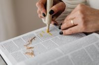 Kaboompics - Woman Highlighting Bible Verses with a Yellow Marker and Gold Cross Necklace, Christian Scripture Study and Faith Lifestyle