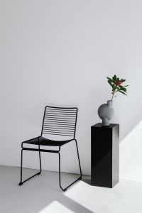 Kaboompics - Minimal Flower Vase and Black Metal Chair in a Bright Room