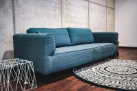 Kaboompics - Blue sofa with pillows in a designer living room interior