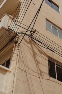 Kaboompics - Overhead Utility Wires on a Weathered Malta Townhouse