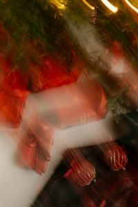 Kaboompics - Warm Fairy Light Motion Blur over Red Gift Boxes and Evergreen Branches