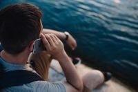 Kaboompics - Over-the-Shoulder View of a Man on a Phone Beside the Sea