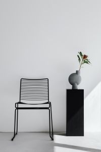 Kaboompics - Black Wire Chair Beside a Gray Vase with Protea