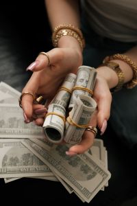 Kaboompics - Hands Holding Rolled Dollar Bills Growth Manifestation