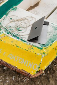 Kaboompics - Open MacBook and Smartphone on a Painted Yellow Boat