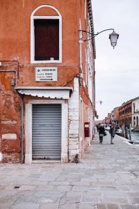 Kaboompics - Murano Glass Sculpture in a Window on a Weathered Terracotta Street, Italy