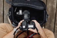 Kaboompics - Photographer holding a DSLR camera