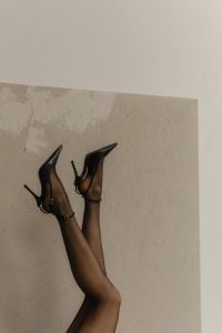 Kaboompics - Black Heels and Legs Posed Against a Textured Wall