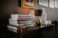 Kaboompics - Black Console Table Styled with Books and Decorative Glassware