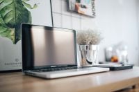 Kaboompics - Silver Acer laptop on a wooden desk with a green plant, pencils and an Apple iPhone