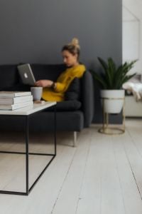 Work From Home Lifestyle: Cozy Remote Work with Laptop, Smartphone and Reading Breaks