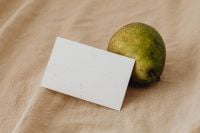 Kaboompics - Speckled Pear and Blank Business Card on Soft Beige Linen