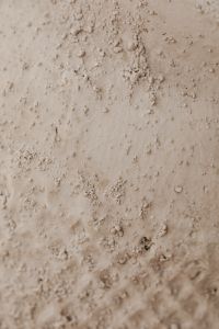 Kaboompics - Pale Beige Plaster Background with Scattered Raised Flecks and Open Smooth Areas