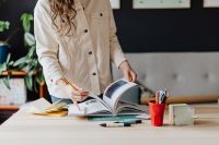 Kaboompics - Woman Standing at Desk with Open Books