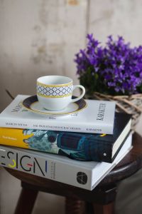 Kaboompics - Books and purple flowers on a wooden stool by the bed