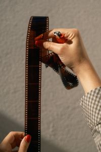 Kaboompics - Holding 35mm Film Negatives And A Lighter