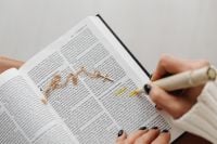 Kaboompics - Open Bible with Gold Cross Necklace and Highlighted Verses