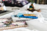 Kaboompics - Stacked Floral Notebooks And Blue Diary On A Soft Bed
