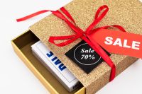 Kaboompics - Open Gold Gift Box with Sale Labels and White Packaging