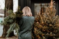 Kaboompics - The woman is holding pine branches in her hands