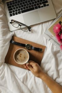 Kaboompics - Work From Bed Flat Lay with Laptop, Coffee, Glasses and Notebook