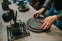 Kaboompics - Woman putting a plate on a table