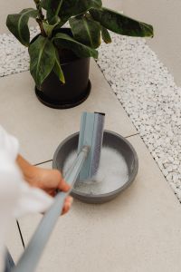 Kaboompics - Woman Rinsing a Mop Head During Home Cleaning