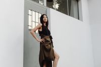 Kaboompics - Full Body Asian Fashion Model in Black Top and Brown Wrap Skirt against White Architecture