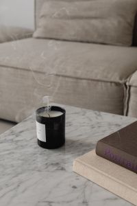 Kaboompics - Smoke Curling from Black Candle on Marble beside Sofa