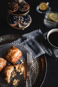 Kaboompics - Sweet Buns, Coffee and Dessert Stand on a Dark Table