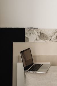 Kaboompics - Laptop on a Sofa Beside Neutral Art and a Light Wall