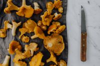 Kaboompics - Chanterelle Mushrooms With Knife On Marble Surface