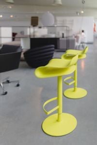Kaboompics - Pair of Lime Yellow Bar Stools in a Contemporary Showroom, Vertical Designer Furniture Photography