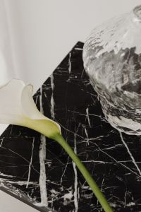 Kaboompics - White Calla Lily and Marble Sphere on Black Marble, Minimal Floral Still Life