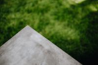 Kaboompics - Concrete side table and green grass in garden
