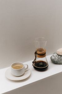 Kaboompics - Coffee Cup, Chemex and Stones on White Shelf