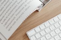 Kaboompics - Home Office Flat Lay of Keyboard, Open Magazine and Oak Desk