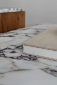 Kaboompics - Neutral Book Styling on Calacatta Viola Marble with Oak Cabinet